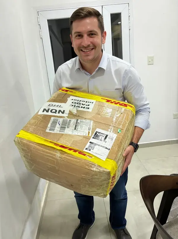 Hombre joven sosteniendo la caja de courier de su pedido